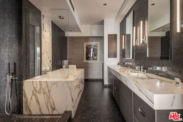 bathroom with vanity and separate shower and tub