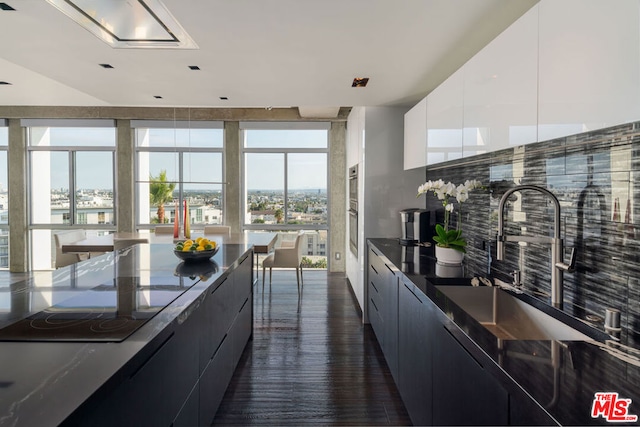 kitchen featuring white cabinetry, sink, and plenty of natural light