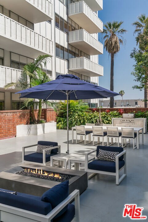 exterior space with an outdoor fire pit and a patio area