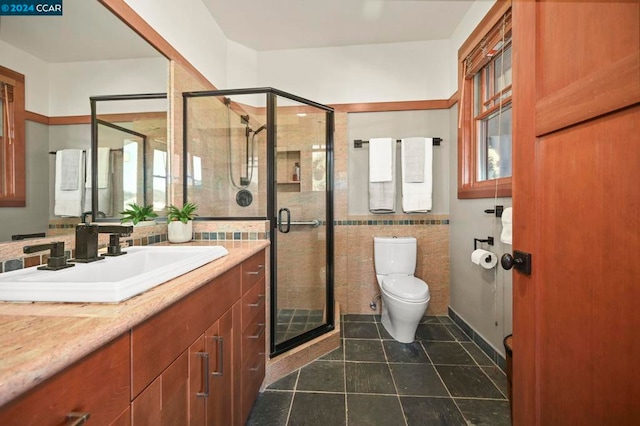 bathroom featuring tile walls, walk in shower, tile patterned floors, vanity, and toilet