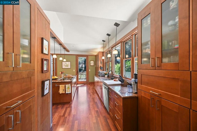 interior space featuring hanging light fixtures, dark wood-type flooring, lofted ceiling, stainless steel dishwasher, and sink