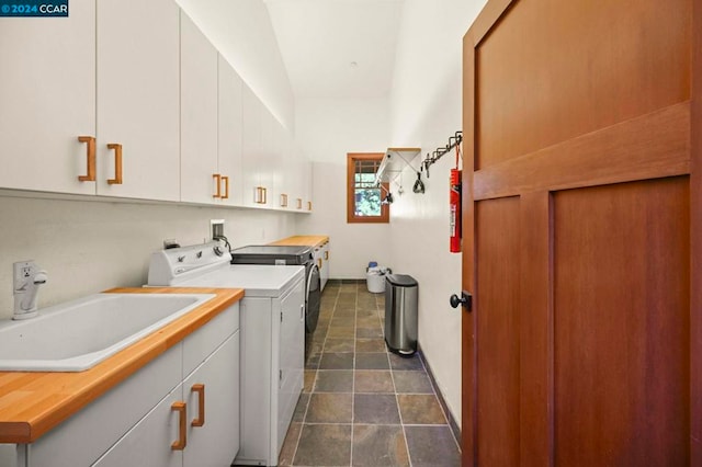 washroom featuring cabinets, washer and dryer, and sink