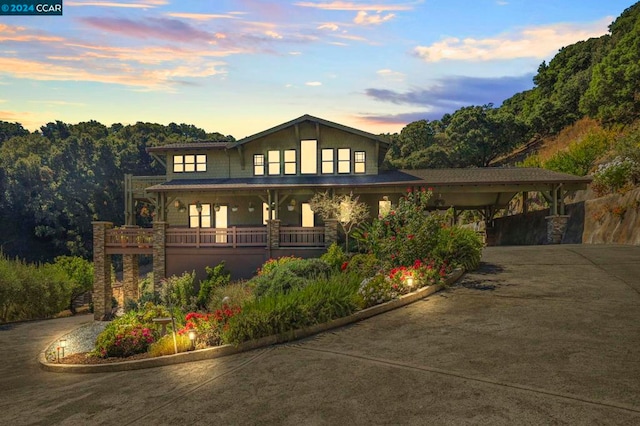 view of front of property with a porch and a carport