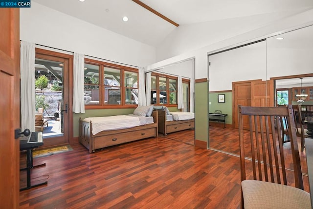 bedroom with two closets, multiple windows, and dark hardwood / wood-style floors