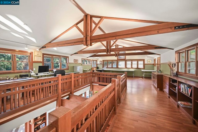 interior space featuring vaulted ceiling with beams and hardwood / wood-style flooring