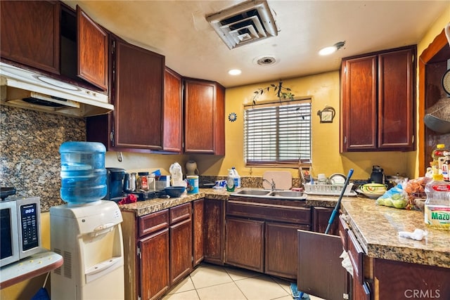 kitchen featuring light tile patterned flooring and sink