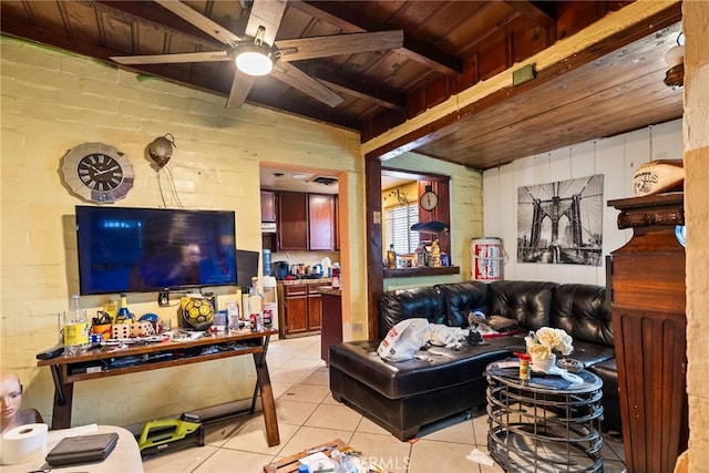 living room with ceiling fan, light tile patterned floors, brick wall, lofted ceiling with beams, and wooden ceiling