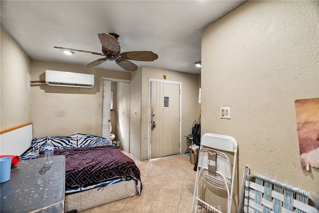 bedroom featuring light tile patterned floors, ceiling fan, and a wall unit AC