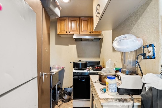 kitchen featuring white appliances and light tile patterned floors