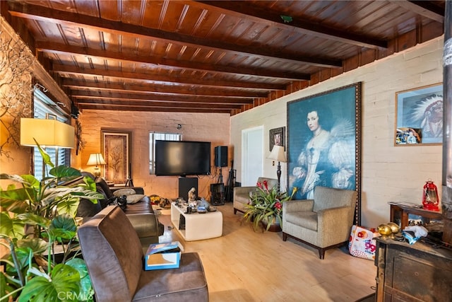 living room featuring brick wall, beamed ceiling, light hardwood / wood-style floors, and wooden ceiling