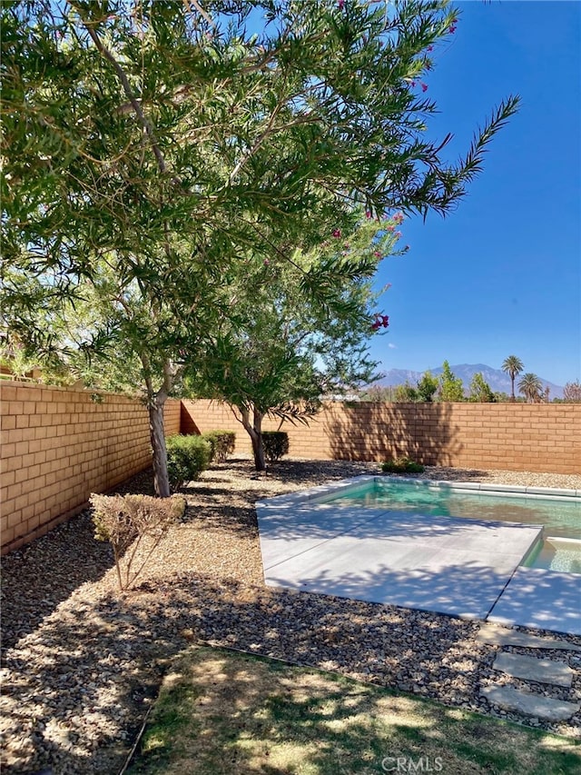 exterior space with a fenced in pool