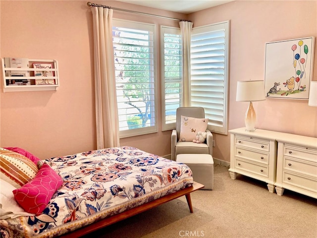 bedroom featuring light colored carpet