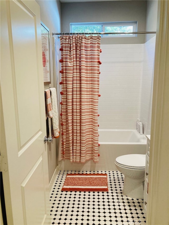 bathroom with tile patterned flooring, shower / bathtub combination with curtain, and toilet