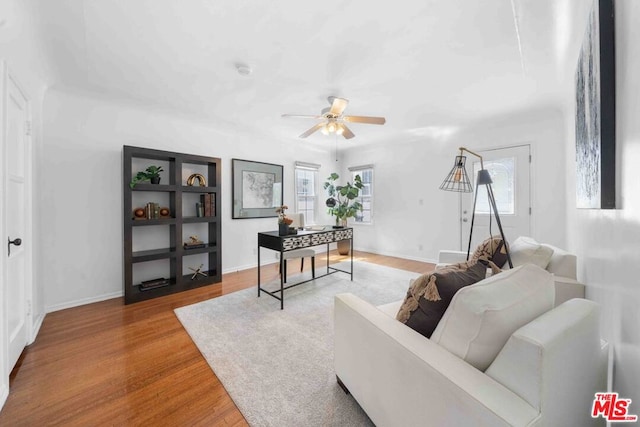 living room featuring ceiling fan and hardwood / wood-style floors