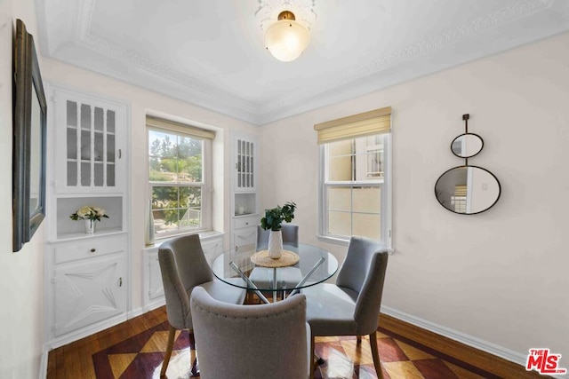 dining room with crown molding and hardwood / wood-style floors