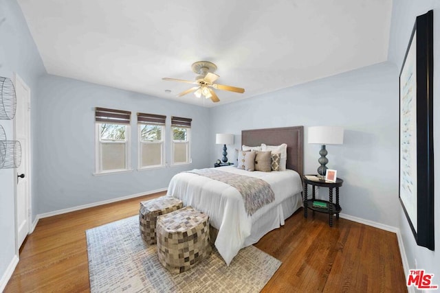 bedroom featuring ceiling fan and dark wood-type flooring