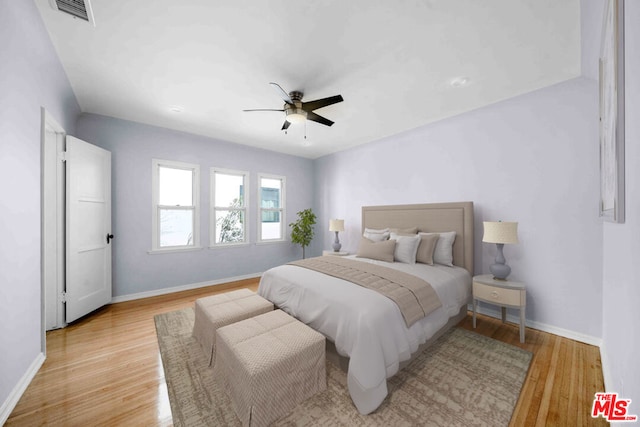 bedroom with ceiling fan and light hardwood / wood-style floors