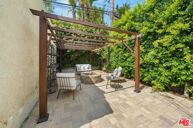 view of patio featuring an outdoor fire pit and a pergola