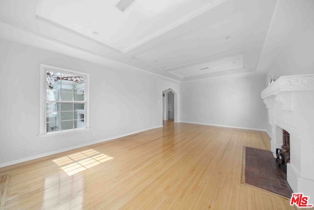 living room featuring light wood-type flooring and a fireplace