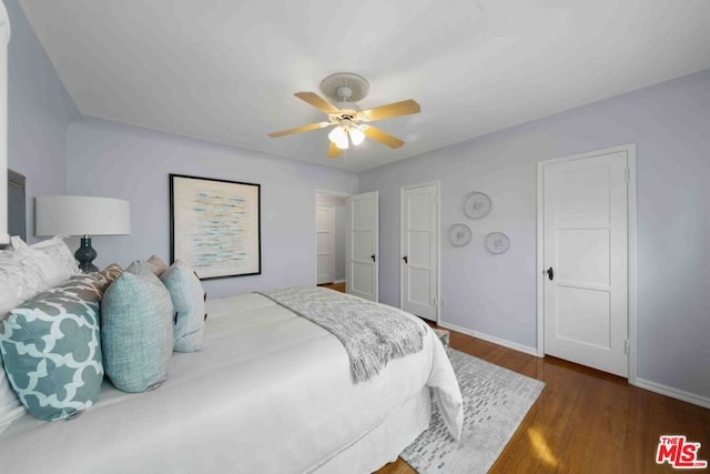 bedroom featuring ceiling fan and dark hardwood / wood-style floors