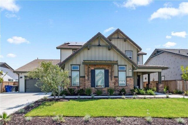 craftsman house featuring a front lawn, a garage, and solar panels