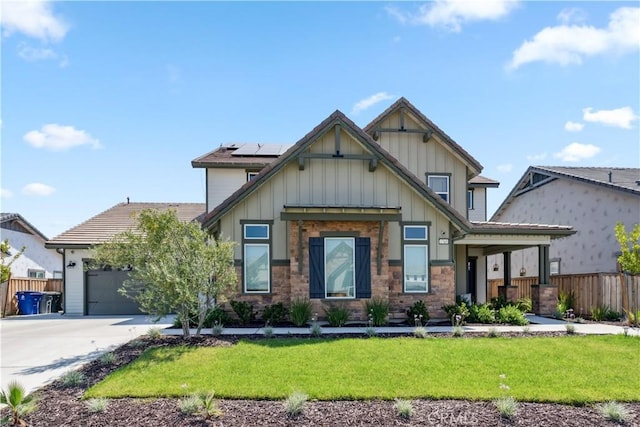 craftsman house with a garage, a front lawn, and solar panels