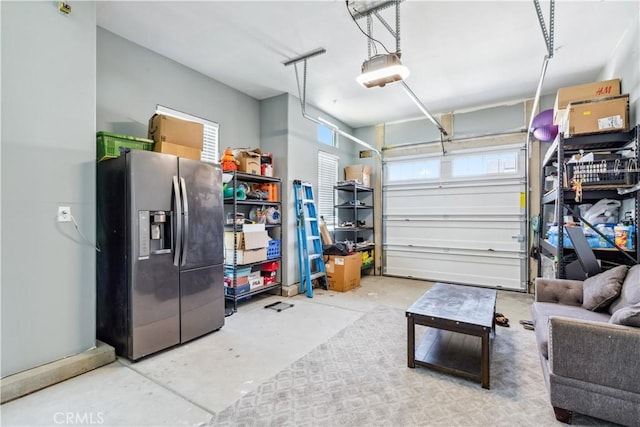 garage featuring a garage door opener and stainless steel fridge