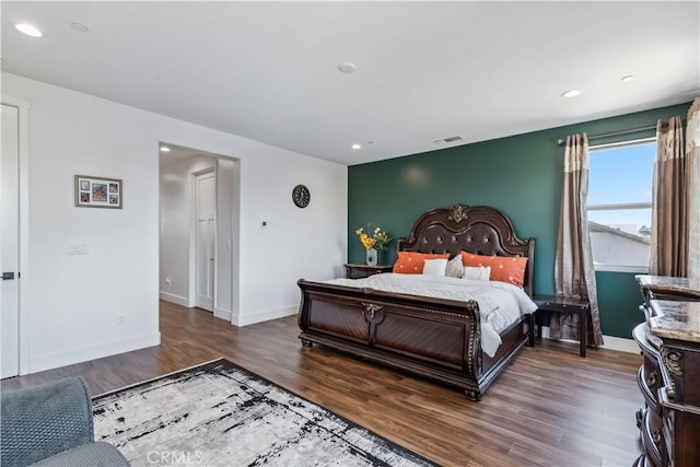 bedroom with dark hardwood / wood-style flooring