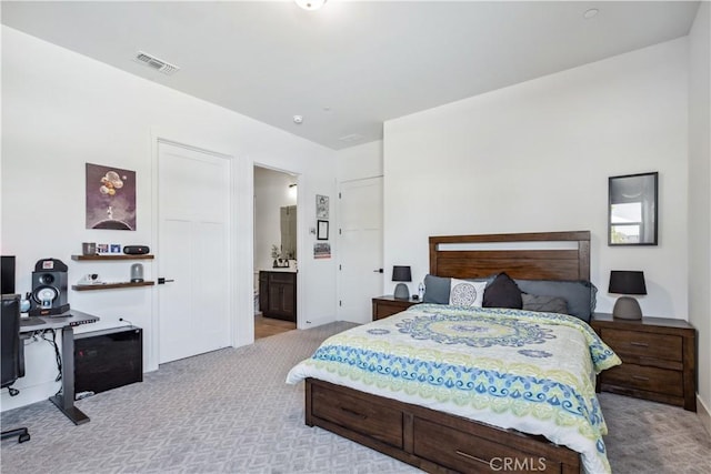 carpeted bedroom with connected bathroom