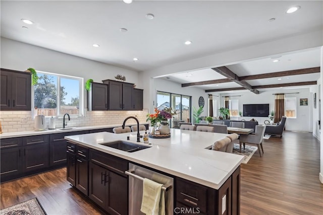 kitchen with an island with sink, sink, dark hardwood / wood-style flooring, and a healthy amount of sunlight