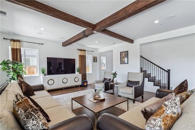 living room featuring beam ceiling and hardwood / wood-style floors