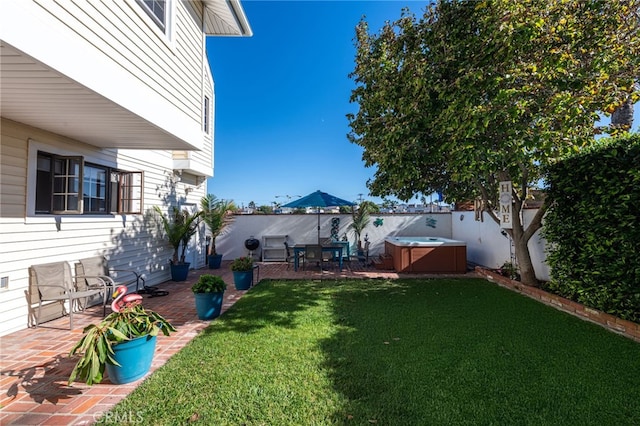 view of yard featuring a patio area, a hot tub, and a fenced backyard