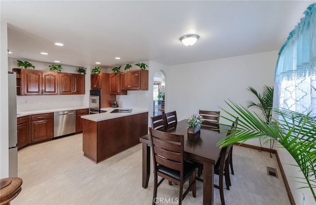 kitchen featuring visible vents, arched walkways, appliances with stainless steel finishes, light countertops, and recessed lighting