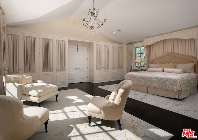 bedroom with a notable chandelier, a closet, hardwood / wood-style floors, and vaulted ceiling