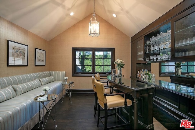 office area with a notable chandelier, dark hardwood / wood-style floors, and vaulted ceiling