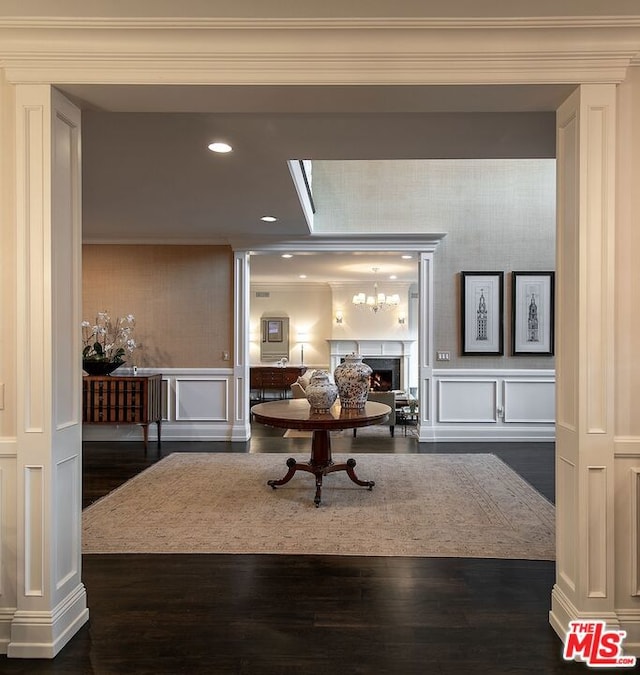 interior space featuring ornamental molding, a skylight, and dark wood-type flooring