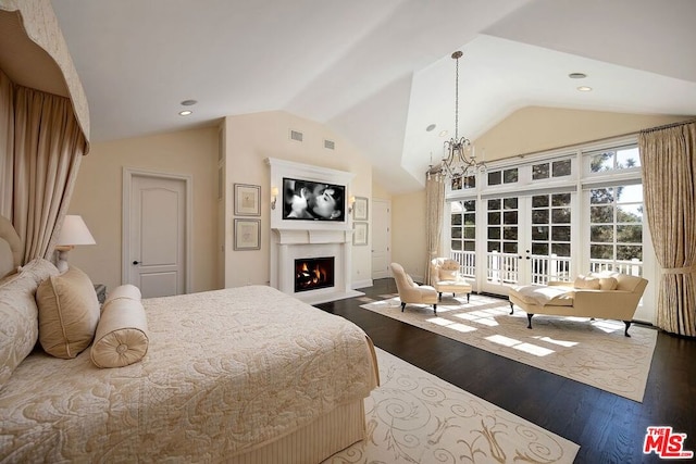 bedroom with an inviting chandelier, wood-type flooring, and lofted ceiling