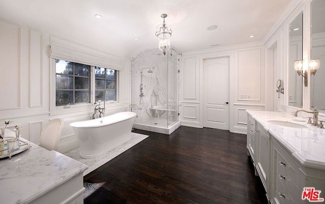 bathroom with wood-type flooring, independent shower and bath, vanity, and crown molding