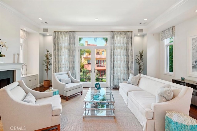 living area with french doors, ornamental molding, and wood-type flooring