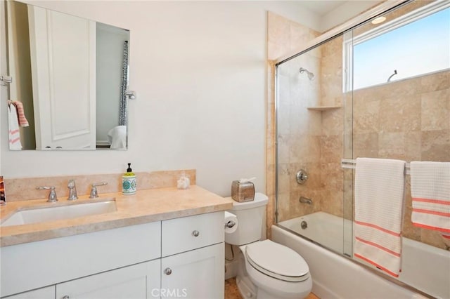 full bathroom with shower / bath combination with glass door, vanity, and toilet