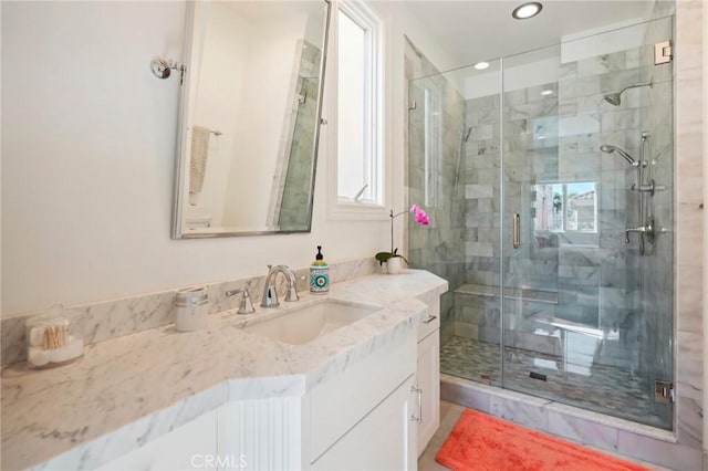 bathroom featuring vanity and an enclosed shower