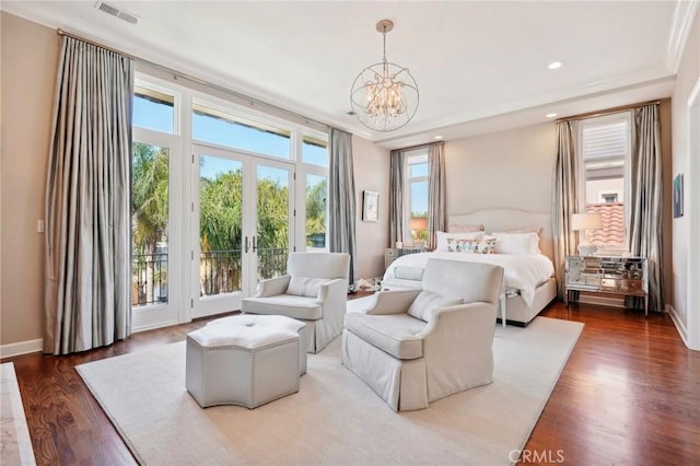 bedroom featuring access to exterior, french doors, ornamental molding, an inviting chandelier, and hardwood / wood-style floors