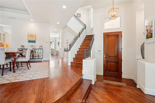 entryway with a chandelier and wood-type flooring