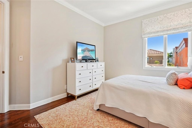 bedroom featuring hardwood / wood-style floors and crown molding