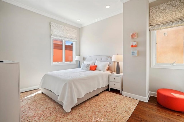 bedroom with hardwood / wood-style flooring and crown molding