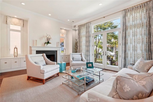 sitting room featuring french doors, light hardwood / wood-style floors, and ornamental molding