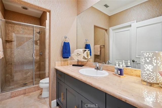 bathroom with tile patterned flooring, vanity, toilet, and walk in shower