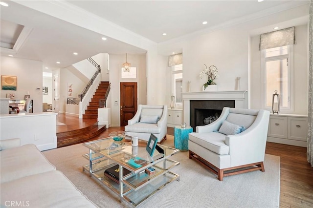 living room featuring light hardwood / wood-style flooring and ornamental molding