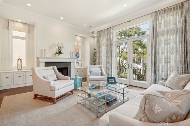 living area with ornamental molding, light hardwood / wood-style floors, and french doors