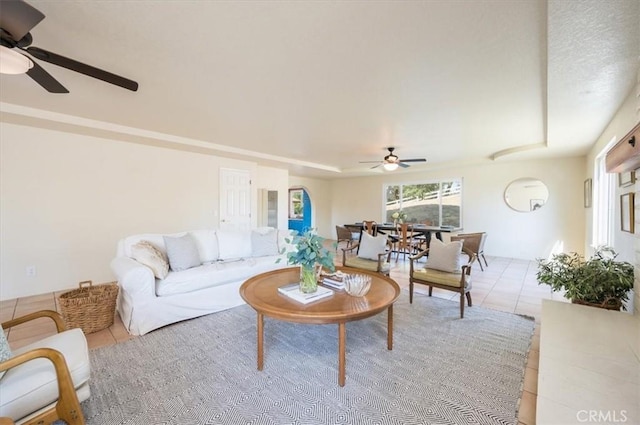 living room featuring ceiling fan and light tile patterned flooring